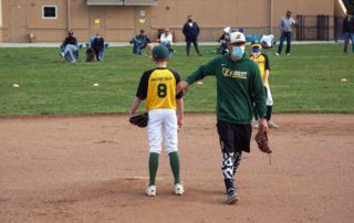 Baseball coach encouraging player during a baseball game