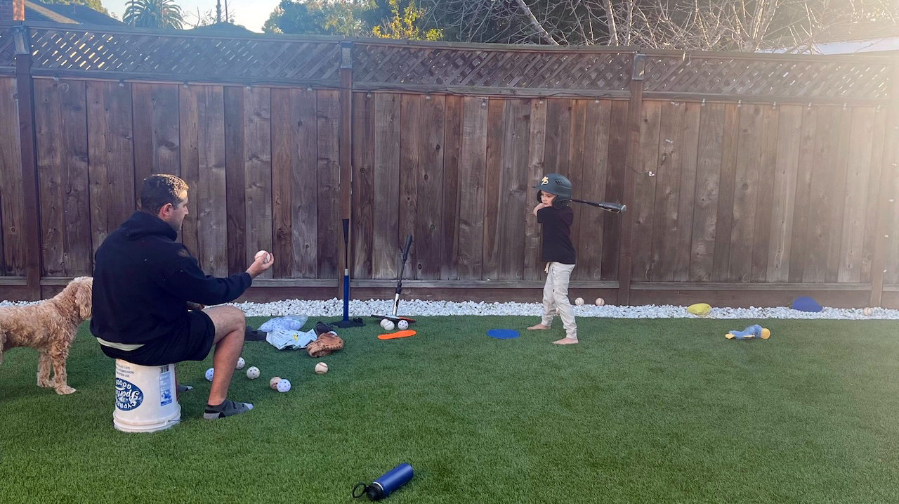 Parent playing catch with their child coach David Klein